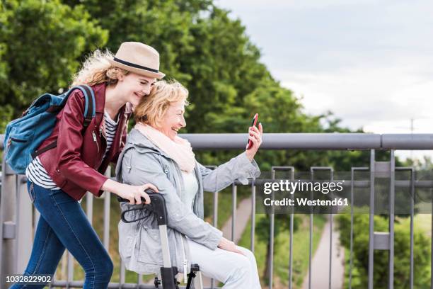 grandmother and granddaughter having fun together - oma rollator stockfoto's en -beelden