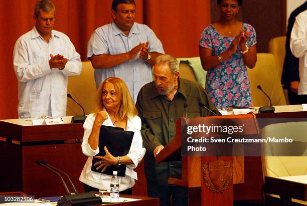 Former Cuban leader Fidel Castro talks with his wife Dalia Soto del Valle during a meeting with the delegates of the National Assembly, on August 7,...