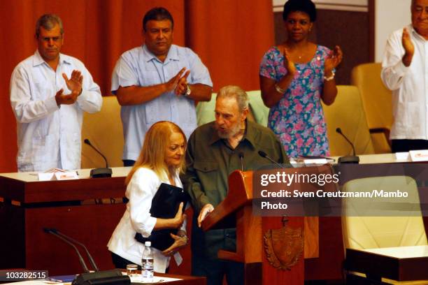 Former Cuban leader Fidel Castro talks with his wife Dalia Soto del Valle during a meeting with the delegates of the National Assembly, on August 7,...