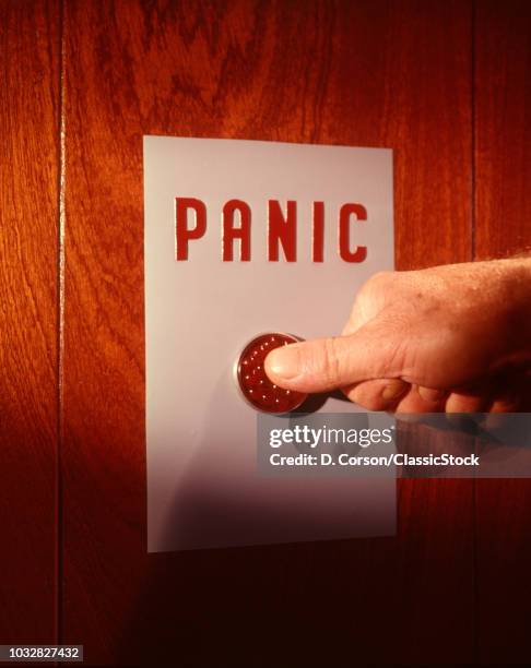 1960s MALE HAND PUSHING PANIC BUTTON