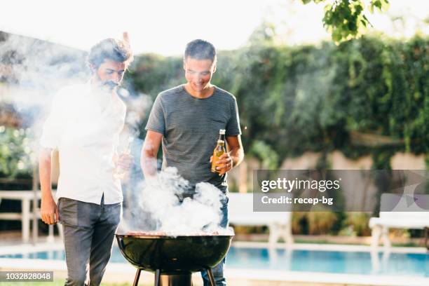 men enjoying beer and chatting in backyard - grill friends and beer stock pictures, royalty-free photos & images