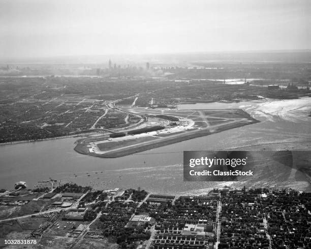 1950s AERIAL ACROSS FLUSHING BAY LA GUARDIA AIRPORT COLLEGE POINT QUEENS MANHATTAN SKYLINE IN DISTANCE LOOKING WEST