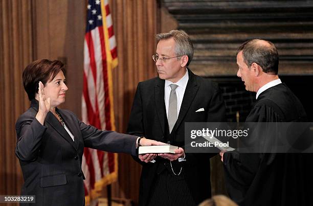 Elena Kagan is sworn in as the Supreme Court's newest member as Chief Justice John Roberts administers the judicial oath, and Jeffrey Minear,...