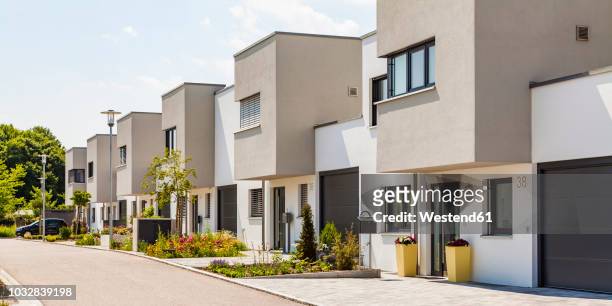 germany, bavaria, neu-ulm, modern one-family houses, efficiency houses - bavarian man in front of house stock-fotos und bilder