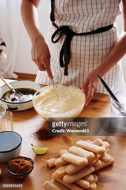 woman stirring mascarpone cream for preparing tiramisu, partial view - female whipping stock-fotos und bilder