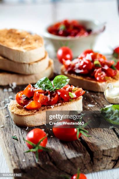 italian buschetta on chopping board - making bruschetta stock pictures, royalty-free photos & images