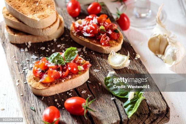 italian buschetta on chopping board - making bruschetta stock pictures, royalty-free photos & images
