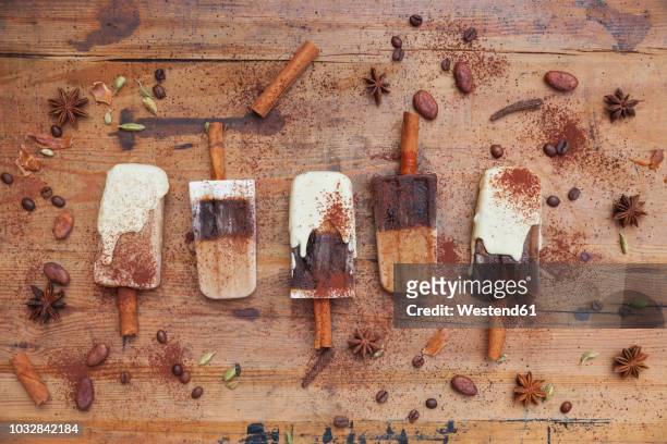 homemade coffee and white chocolate ice lollies with winter spices on wooden background - mocha ice cream stock pictures, royalty-free photos & images