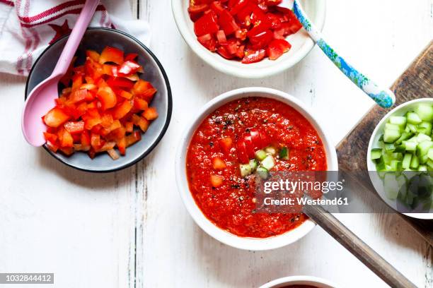 bowl of gazpacho with cucumber and bell pepper topping - gazpacho stock pictures, royalty-free photos & images