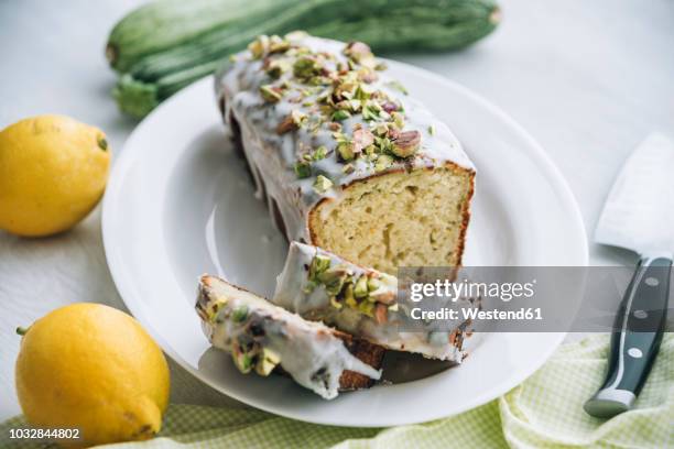 lemon zucchini cake with lemon icing and pistachio topping - pistachio nut stock pictures, royalty-free photos & images