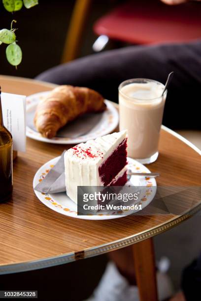 fancy cake, croissant and glass of latte macchiato on a table - croissant café stock pictures, royalty-free photos & images