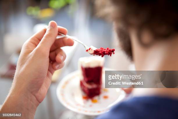 young man eating fancy cake, close-up - eating cake stock pictures, royalty-free photos & images