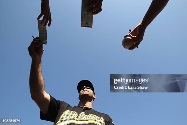 Kevin Kouzmanoff of the Oakland Athletics signs autographs after their game against the Texas Rangers at the Oakland-Alameda County Coliseum on...