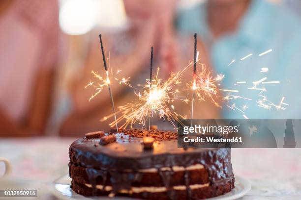 chocolate birthday cake with sprklers - birthday cake stock pictures, royalty-free photos & images