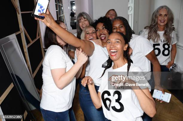 Models celebrate backstage at the JDW Midster Live AW18 Catwalk Show and party presented by JD Williams during London Fashion Week September 2018 at...