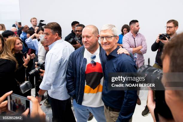Apple Chief Design Officer Jonathan Ive poses for pictures with CEO Tim Cook during a launch event on September 12 in Cupertino, California. - New...