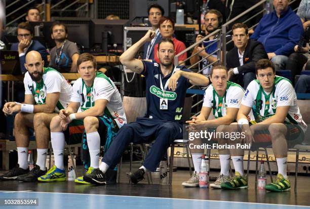 Domagoj Srsen, Pavel Atman, assistant coach Iker Romero, Jannes Krone and Joshua Thiele of TSV Hannover Burgdorf during the game between Fuechse...