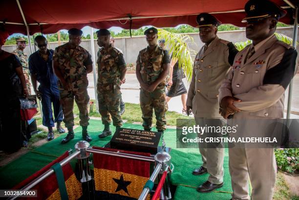 Soldiers and army officials stand next to the grave of Kofi Annan during his funeral at the Burma Camp military cemetery in Accra on September 13...