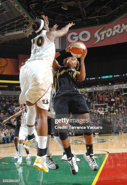 Amber Holt of the Tulsa Shock goes to the basket against Camille Little of the Seattle Storm on August 7, 2010 at Key Arena in Seattle, Washington....