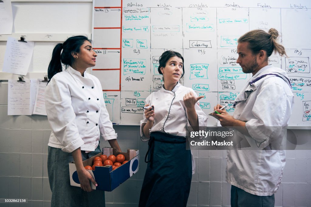 Communication Between Cooks Chefs Communicating Against Whiteboard In Kitchen High-Res Stock Photo ...