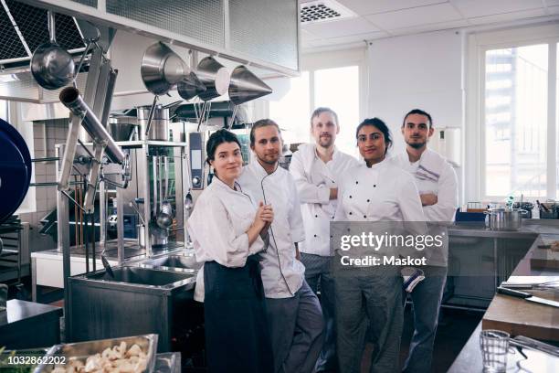 portrait of chefs standing together in commercial kitchen - chef's whites stock-fotos und bilder