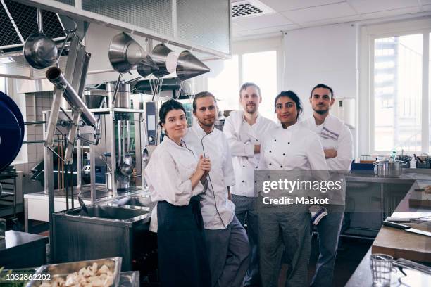 portrait of chefs standing together in commercial kitchen - chefs whites stock pictures, royalty-free photos & images