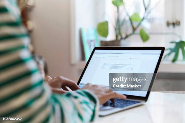 cropped image of entrepreneur using laptop while sitting at home - blogging bildbanksfoton och bilder