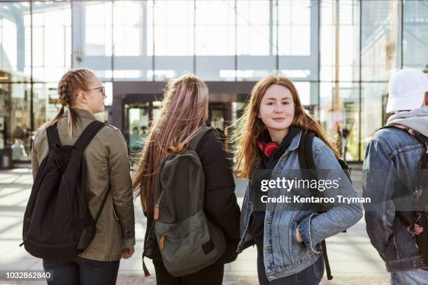 portrait of teenage girl with friends against railroad station in city - boys friends stock-fotos und bilder