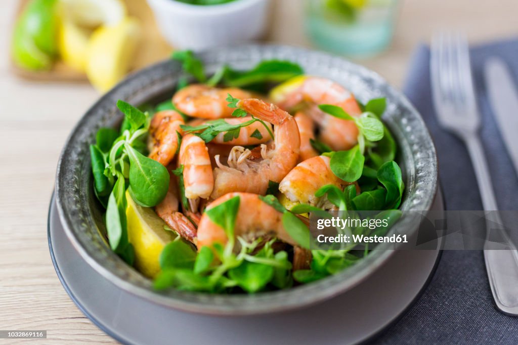 Shrimps with lamb's lettuce on plate