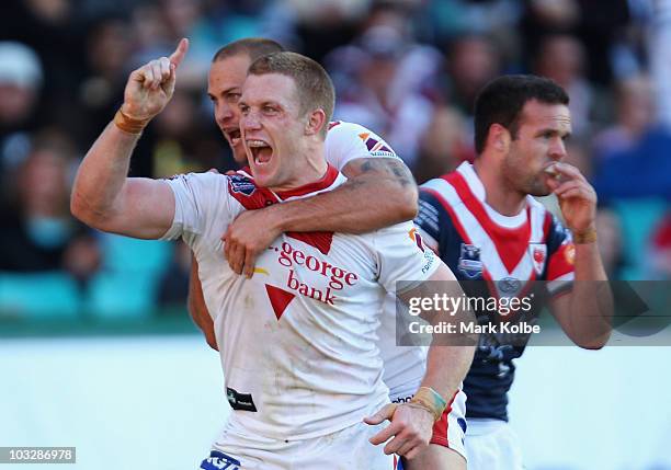 Ben Creagh of the Dragons celebrates after scoring a try with Matt Cooper during the round 22 NRL match between the Sydney Roosters and the St George...