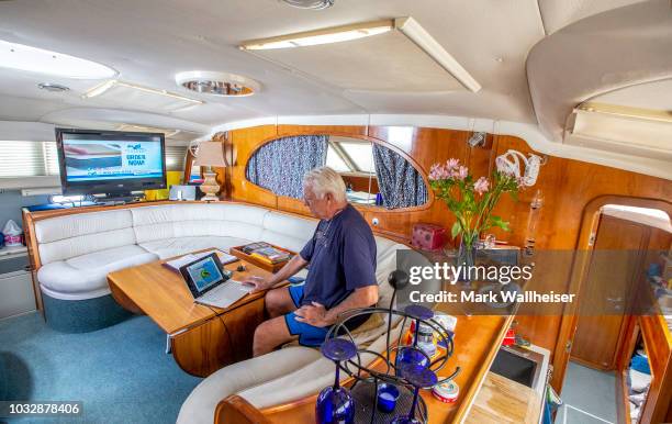 William Harrison checks the weather inside his 46 foot Prout catamaran where he plans to stay during Hurricane Florence while it's moored at the...