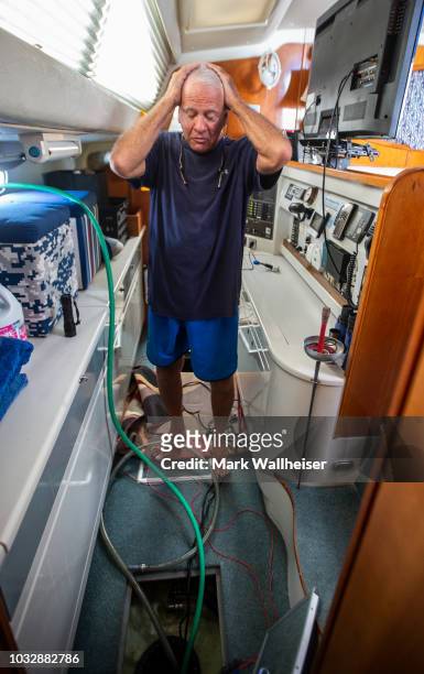 William Harrison anguishes as he bilges the hulls on his 46 foot Prout catamaran where he plans to stay during Hurricane Florence while it's moored...