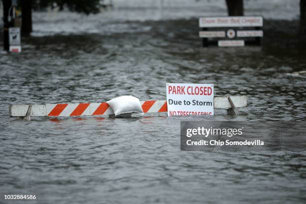 Sign warns people away from Union Point Park after is was flooded by the Neuse River during Hurricane Florence September 13, 2018 in New Bern, North...