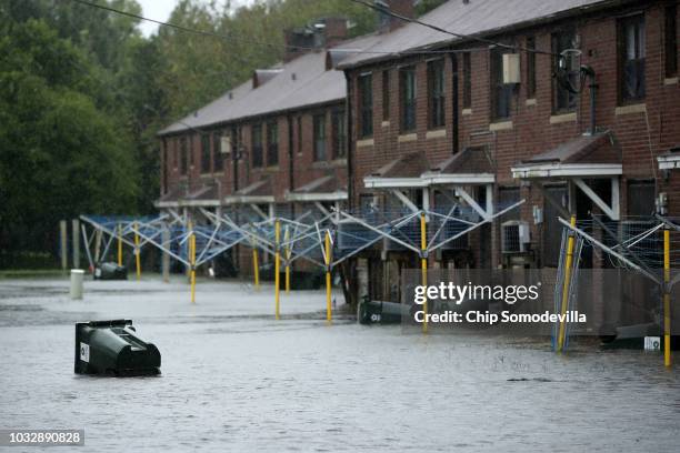 Transh can floats through the Trent Court public housing apartments after the Neuse River topped its banks during Hurricane Florence September 13,...