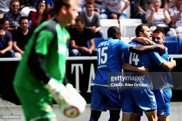 Josip Simunic of Hoffenheim celebrates his team's first goal with team mates Peniel Mlapa and Vedad Ibisevic during the pre-season friendly match...