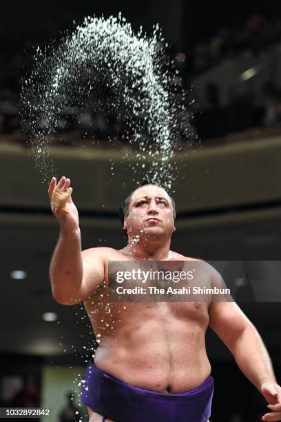 Goergian ozeki Tochinoshin sprinkles salt prior to his bout against sekiwake Mitakeumi on day five of the Grand Sumo Autumn Tournament at Ryogoku...