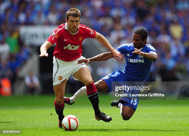 Michael Carrick of Manchester United is tackled by Florent Malouda of Chelsea during the FA Community Shield match between Chelsea and Manchester...