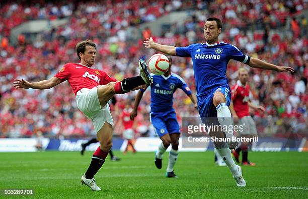 John Terry of Chelsea challenges Michael Owen of Manchester United during the FA Community Shield match between Chelsea and Manchester United at...