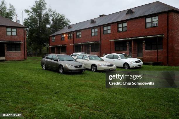 Residents park their cars on high ground in between apartment buildings in the Trent Court public housing after the Neuse River flooded its banks...