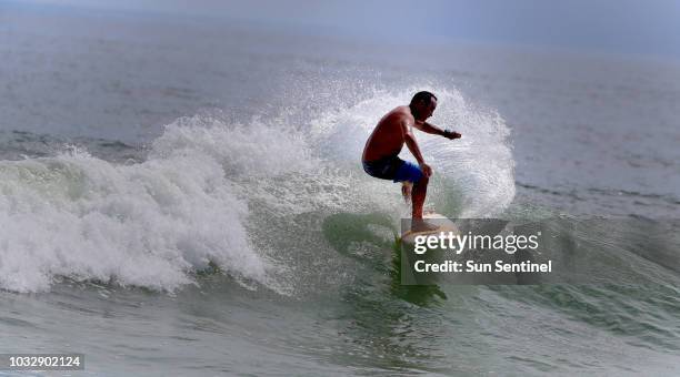 Juno Beach surfer Jamie Vignone of Jupiter, Fla., takes advantage of the strong surf caused by Hurricane Florence as it approaches the Carolinas on...