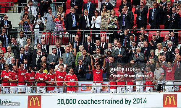 Nemanja Vidic of Manchester United lifts the trophy after victory in the FA Community Shield match between Chelsea and Manchester United at Wembley...