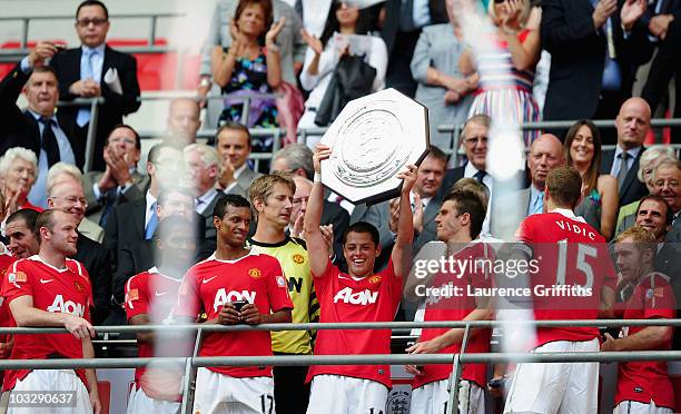 Javier Hernandez of Manchester United lifts the trophy and celebrates with team mates after victory in the FA Community Shield match between Chelsea...