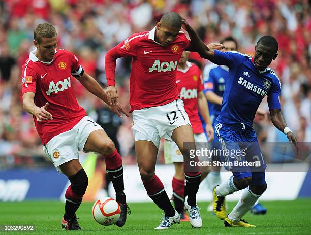 Nemanja Vidic of Manchester United collects the ball from Chris Smalling after he loses the ball under pressure by Salomon Kalou of Chelsea during...