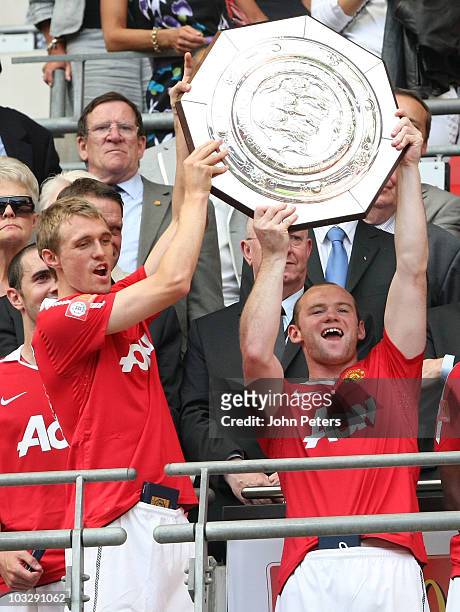 Darren Fletcher and Wayne Rooney of Manchester United hold aloft the Community Shield trophy after the FA Community Shield match between Chelsea and...