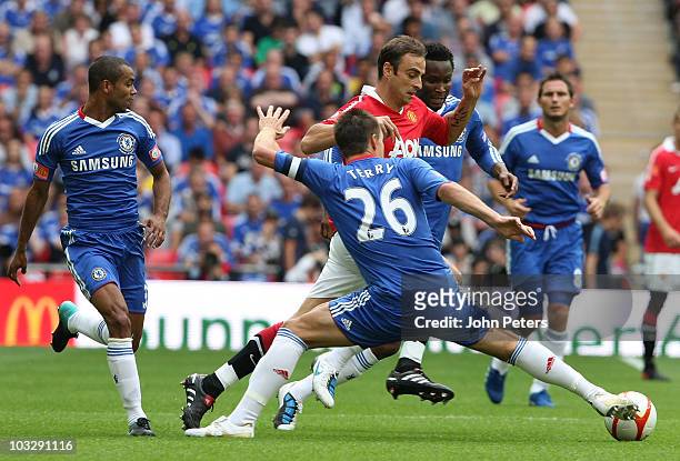 Dimitar Berbatov of Manchester United clashes with John Terry of Chelsea during the FA Community Shield match between Chelsea and Manchester United...