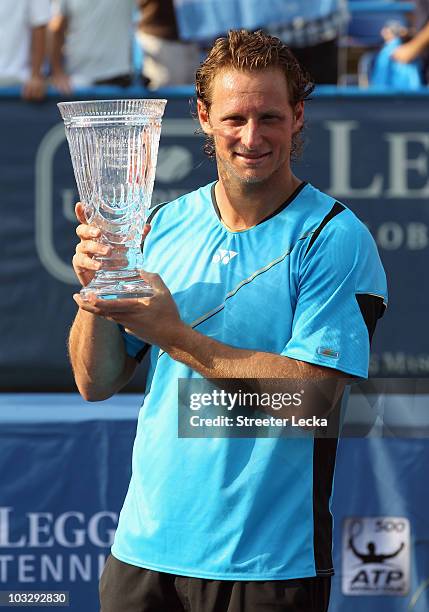 David Nalbandian of Argentina poses with the trophy after defeating Marcos Baghdatis of Cyprus during the singles final on day 7 of the Legg Mason...