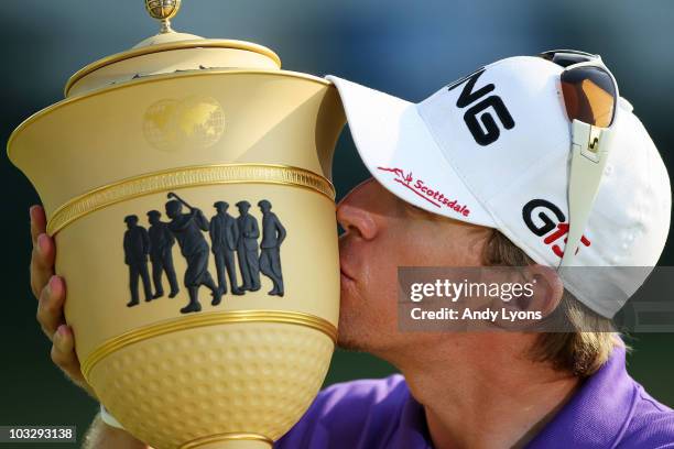 Hunter Mahan kisses the Gary Player Cup after winning the World Golf Championships - Bridgestone Invitational on the South Course at Firestone...