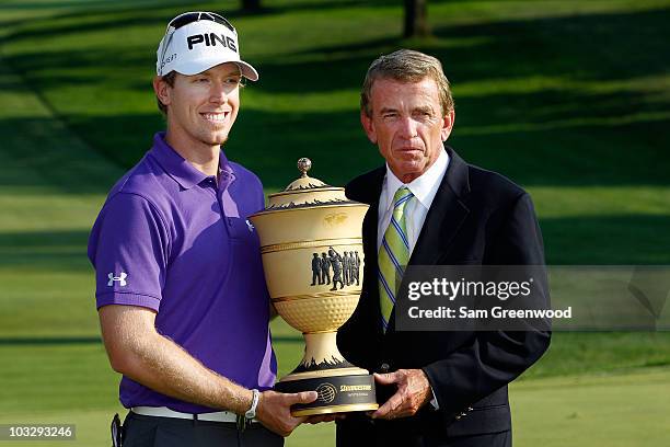 Hunter Mahan smilles while holding the Gary Player Cup alongside PGA TOUR Commissioner, Tim Finchem, after winning the World Golf Championships -...