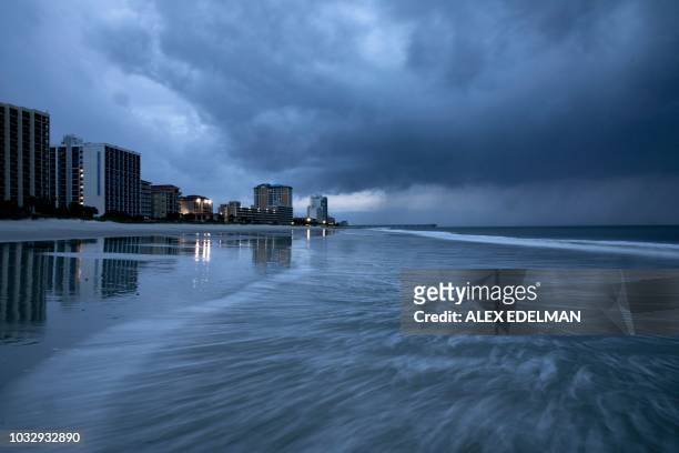 Rain begins to fall as the outer bands of Hurricane Florence make landfall in Myrtle Beach, South Carolina on September 13, 2018. - Hurricane...