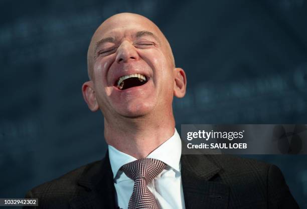 Jeff Bezos, founder and CEO of Amazon, laughs as he speaks during the Economic Club of Washington's Milestone Celebration event in Washington, DC, on...